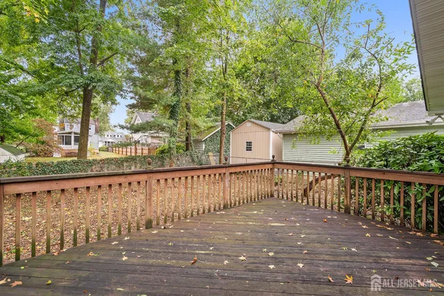 a view of balcony with wooden floor and fence