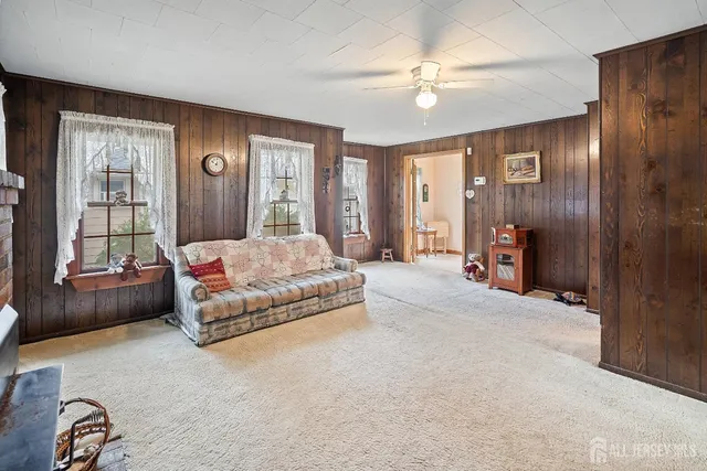 a spacious bedroom with a large bed and a chandelier