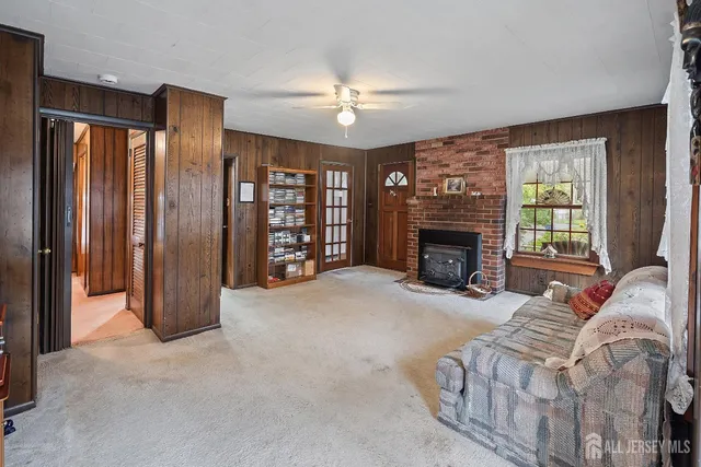 a living room with furniture a fireplace and a chandelier