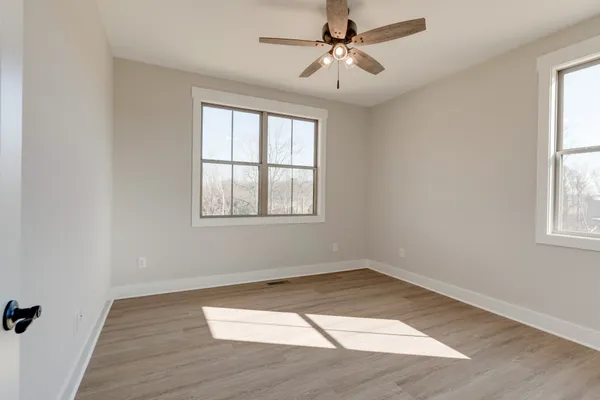 wooden floor in an empty room with a window