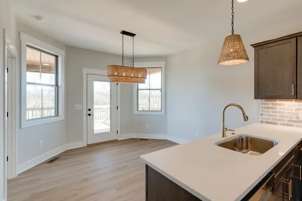 a kitchen with a sink a counter space and a window