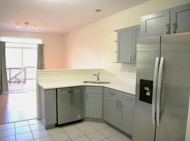 a kitchen with a sink cabinets and refrigerator