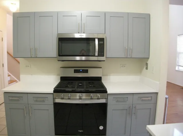 a kitchen with microwave cabinets and a stove top oven