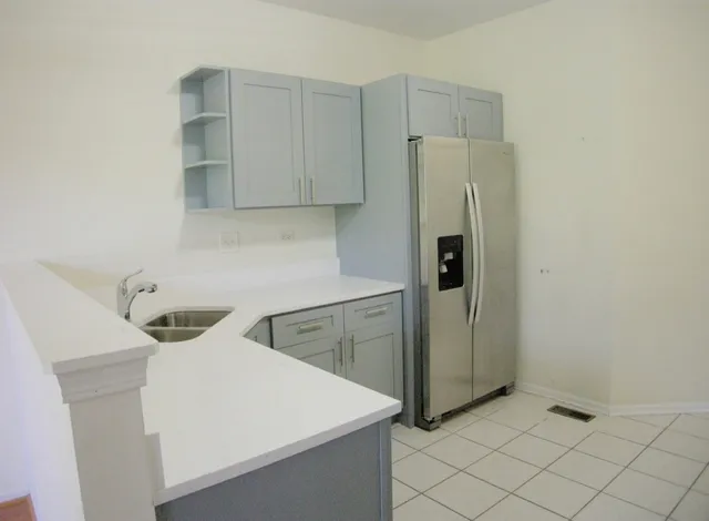 a kitchen with a refrigerator and cabinets