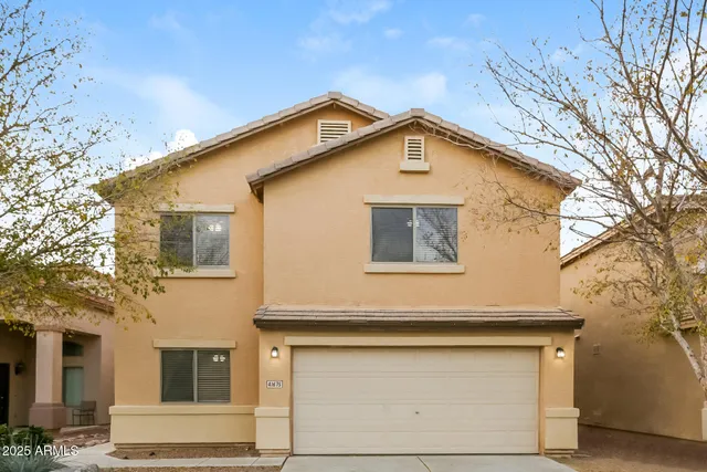 a view of a house with a garage and balcony