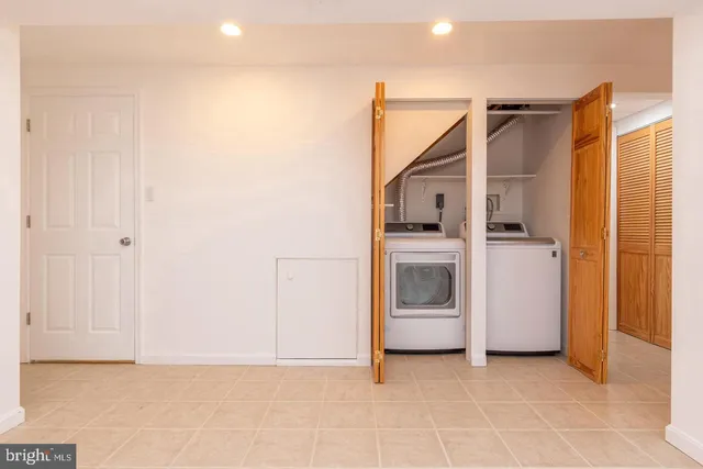 a view of a house with a yard and potted plants