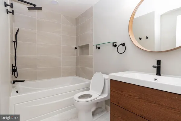 a bathroom with a sink a toilet and a mirror