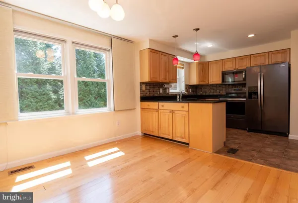 a kitchen with stainless steel appliances granite countertop a stove and a refrigerator