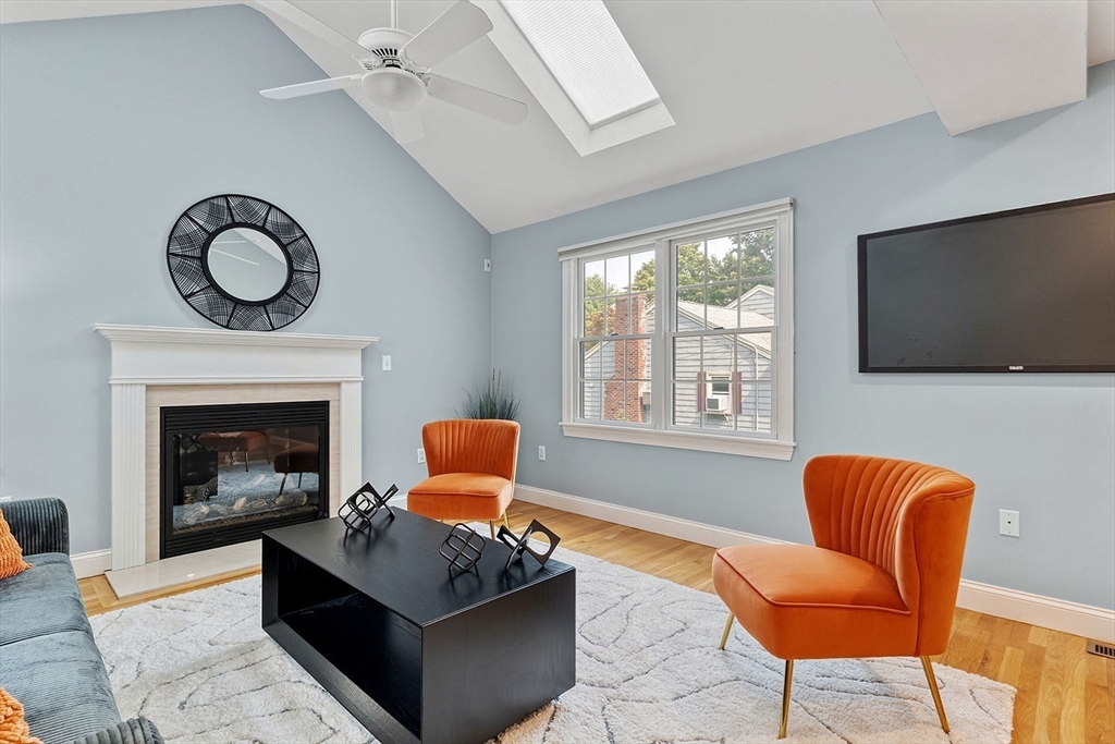 166 Forest Street Winchester, MA 01890 - Photo 12 of 37 a living room with furniture a fireplace and a flat screen tv