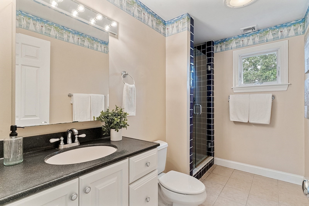 166 Forest Street Winchester, MA 01890 - Photo 18 of 37 a bathroom with a granite countertop sink toilet and shower