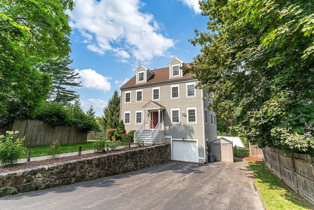 166 Forest Street Winchester, MA 01890 - Photo 2 of 37 a front view of a house with a garden