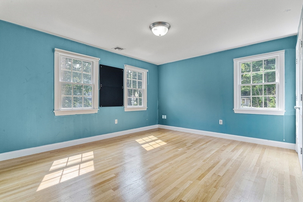 166 Forest Street Winchester, MA 01890 - Photo 22 of 37 a view of an empty room with wooden floor and a window
