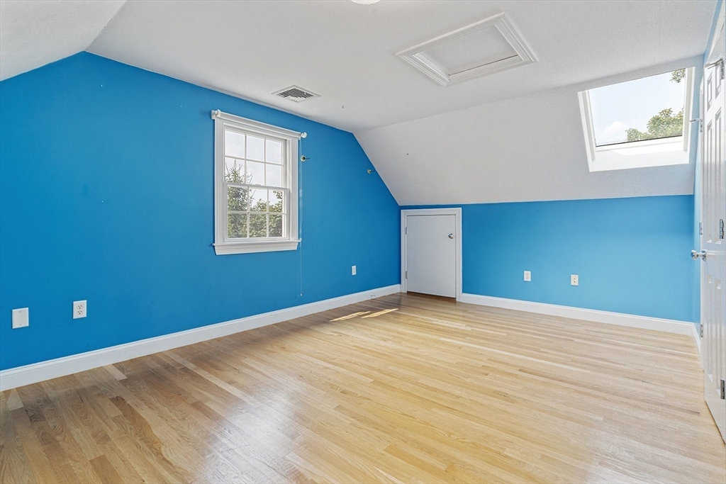 166 Forest Street Winchester, MA 01890 - Photo 25 of 37 a view of an empty room with wooden floor and a window