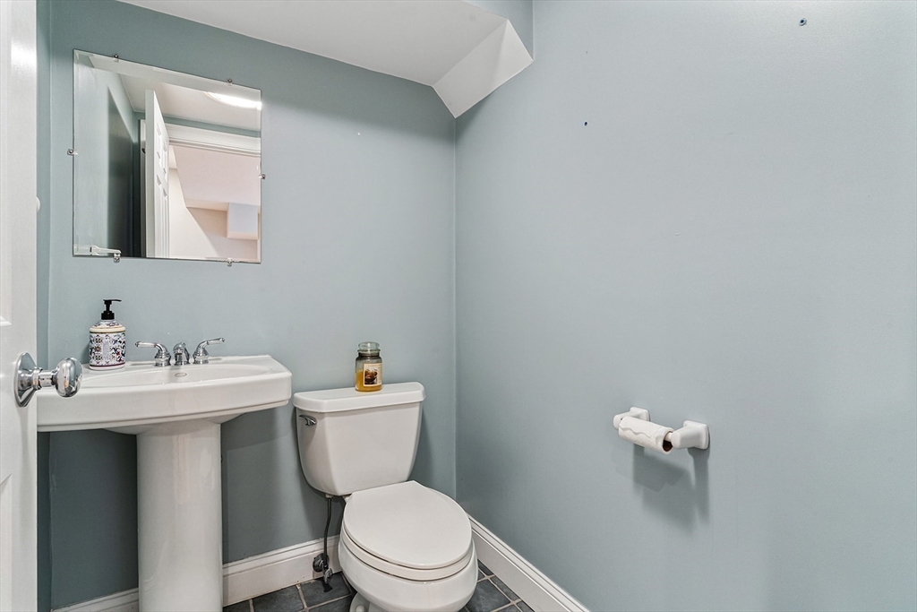 166 Forest Street Winchester, MA 01890 - Photo 31 of 37 a bathroom with a toilet a sink and mirror