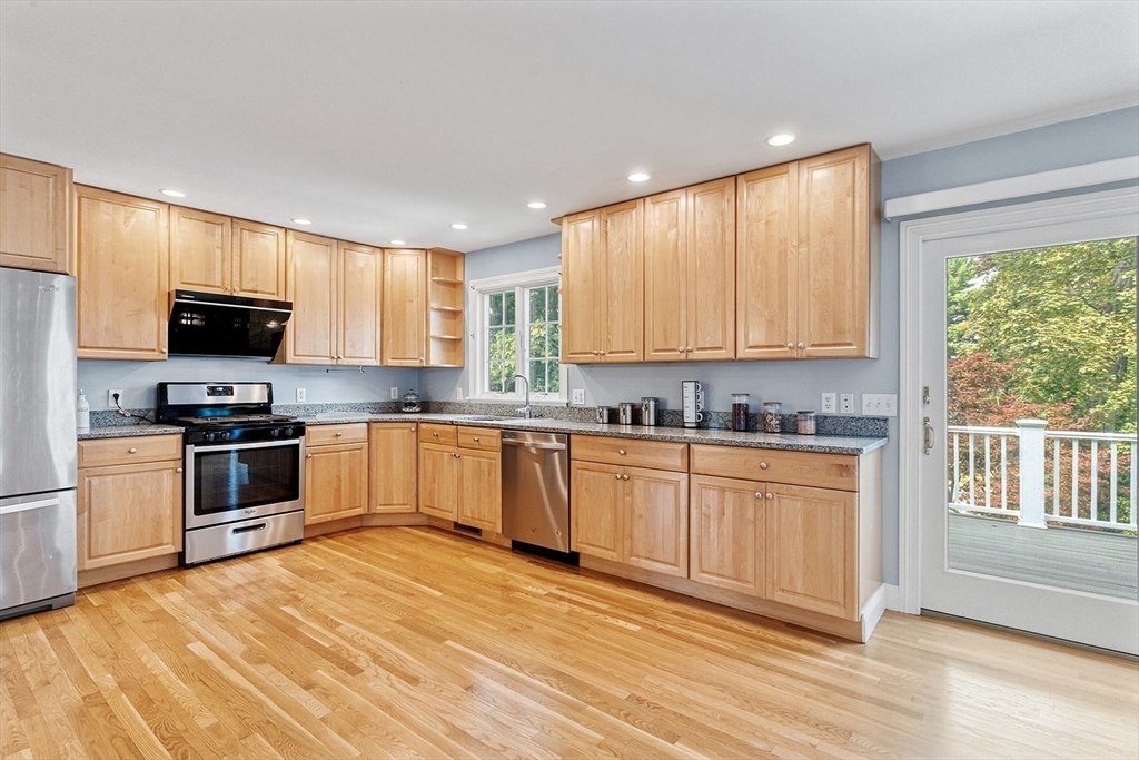 166 Forest Street Winchester, MA 01890 - Photo 8 of 37 a large kitchen with granite countertop a stove a sink and a microwave