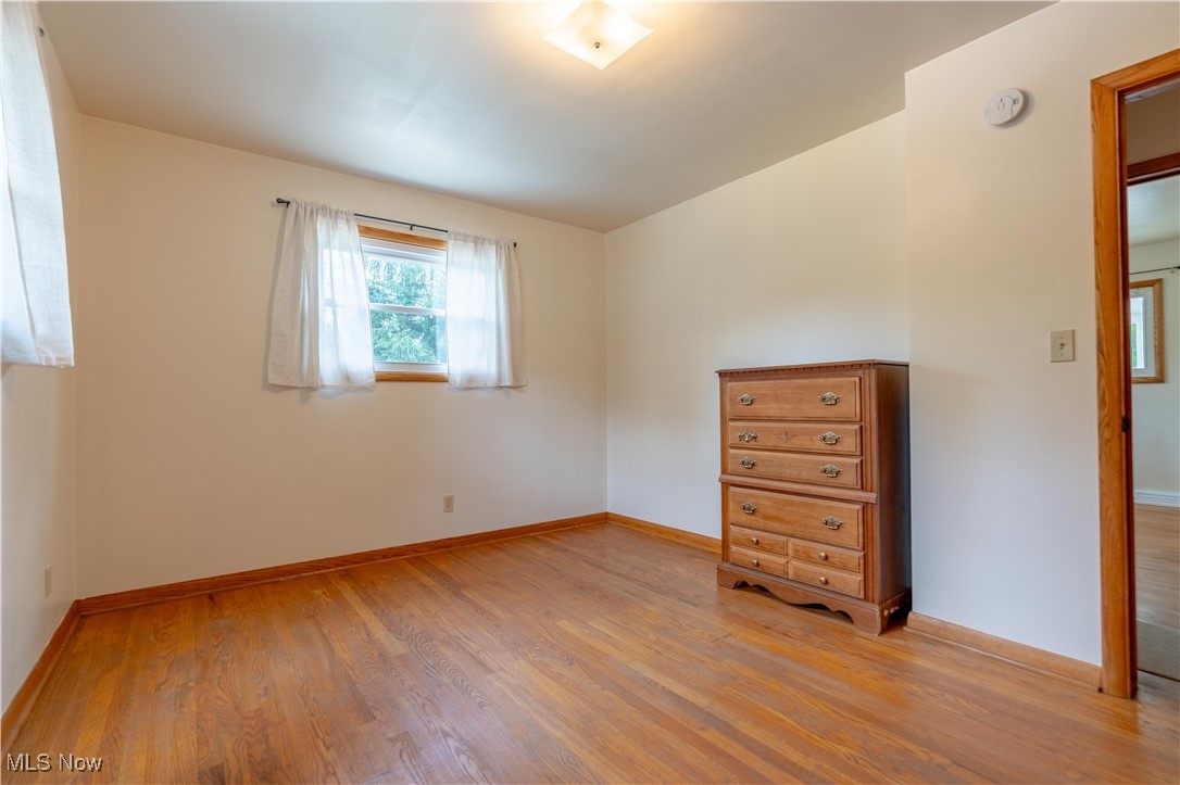 1766 Far View Road Akron, OH 44312 - Photo 14 of 33 Unfurnished bedroom featuring hardwood floors and baseboards