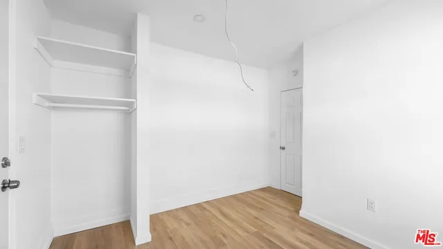 a kitchen with a stove a refrigerator and a window