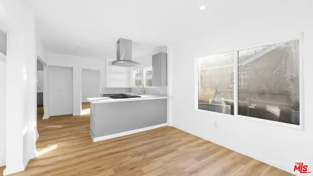 a kitchen with stainless steel appliances granite countertop a sink a stove and a window