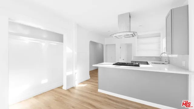 a kitchen with a sink stove and cabinets