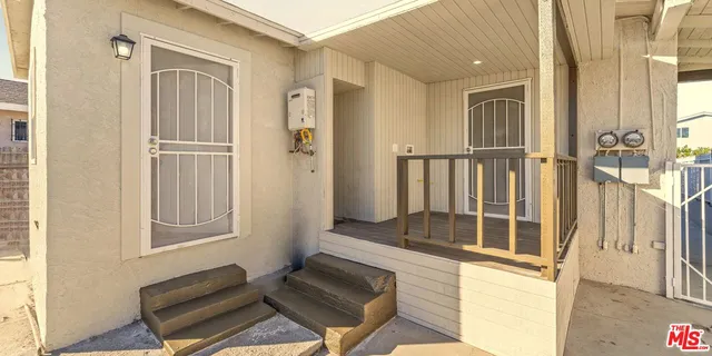 a hallway with a white stove top oven and sink
