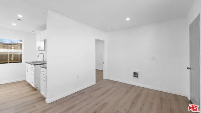 a view of hallway with wooden floor