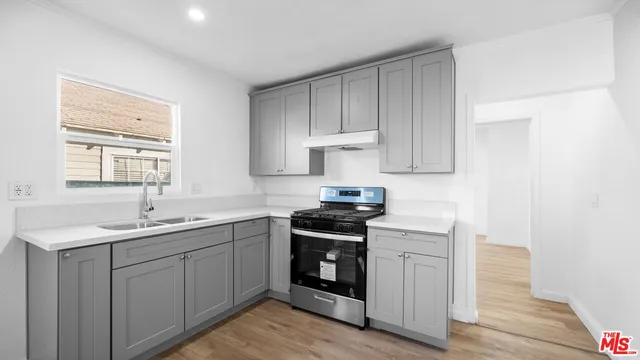 a view of empty room with wooden floor and fireplace