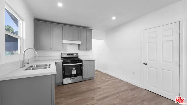 a bathroom with a bathtub shower sink vanity and toilet