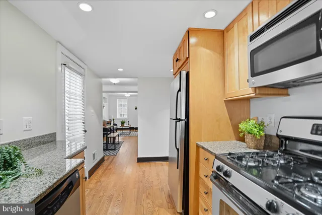 a kitchen with stainless steel appliances granite countertop a stove and a refrigerator