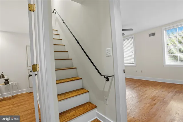 a view of entryway and hall with wooden floor
