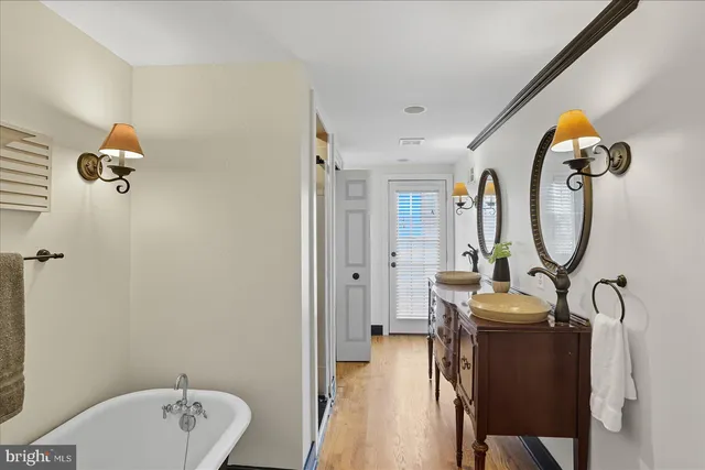 a bathroom with a sink mirror and toilet
