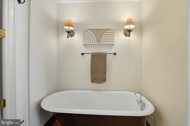a bathroom with a white tub and sink