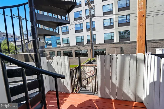 a view of staircase with railing and white walls