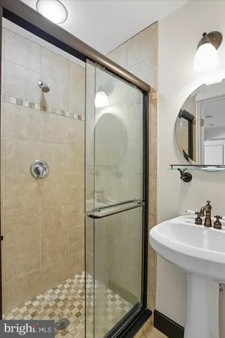 a bathroom with a shower and a sink