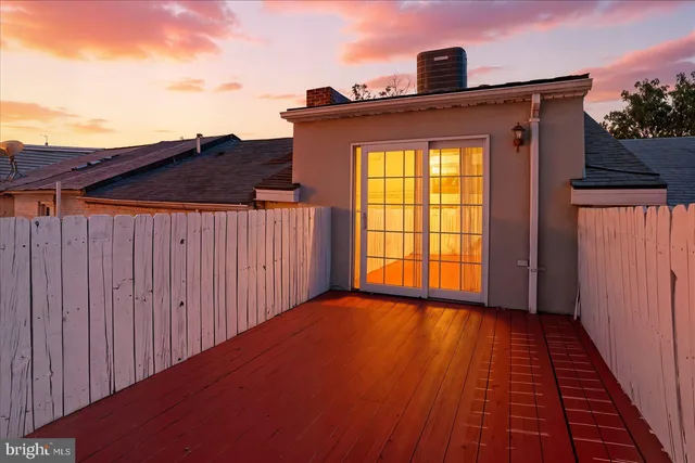 a front view of a house with wooden fence