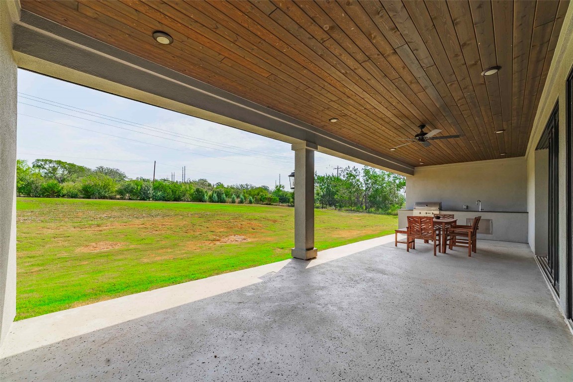 104 Lazy Oak Place Spicewood, TX 78669 - Photo 16 of 40 a view of a lake with a table and chairs under an umbrella
