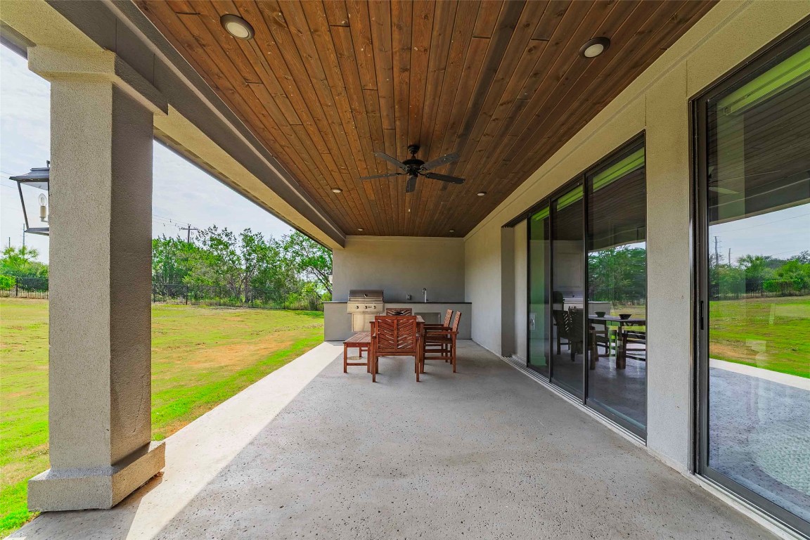 104 Lazy Oak Place Spicewood, TX 78669 - Photo 17 of 40 a view of a patio with a table chairs and a patio