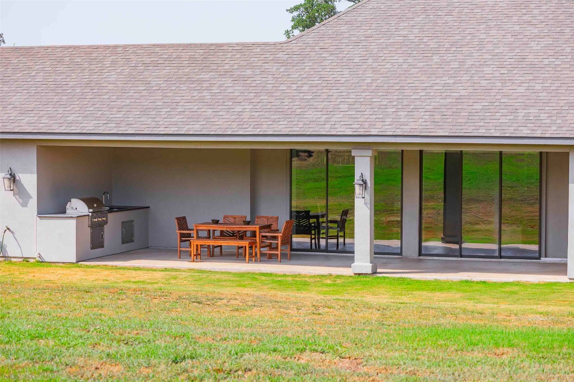 104 Lazy Oak Place Spicewood, TX 78669 - Photo 19 of 40 a backyard of a house with table and chairs