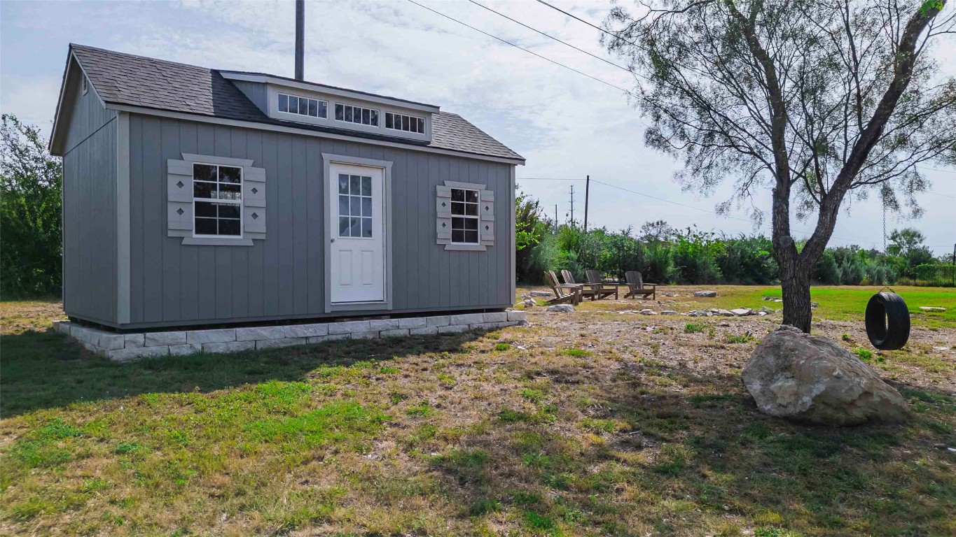 104 Lazy Oak Place Spicewood, TX 78669 - Photo 21 of 40 a backyard of a house with barbeque oven
