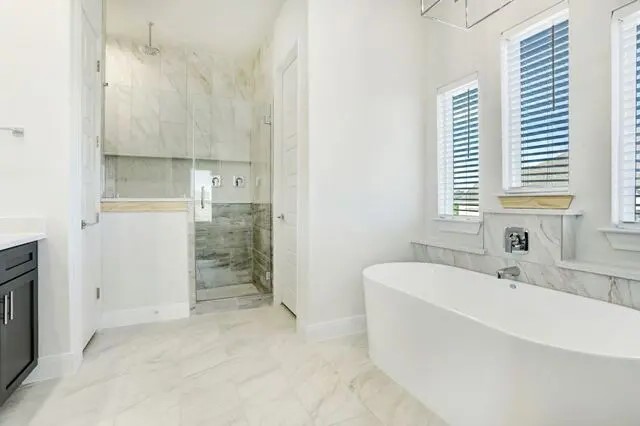 104 Lazy Oak Place Spicewood, TX 78669 - Photo 31 of 40 a bathroom with a bathtub and a sink