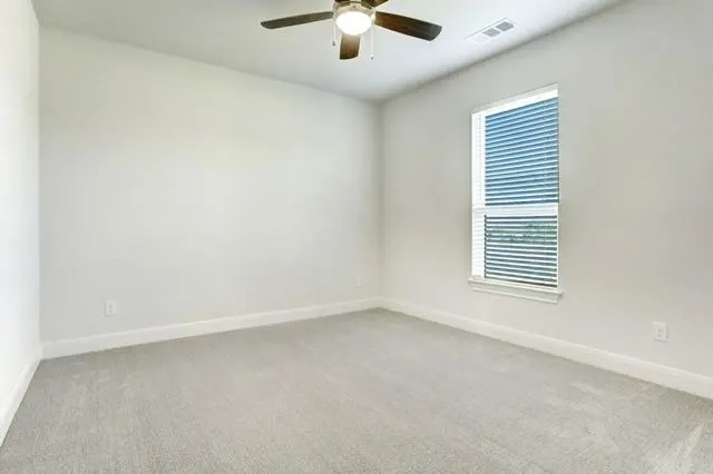 104 Lazy Oak Place Spicewood, TX 78669 - Photo 32 of 40 an empty room with a window and a ceiling fan