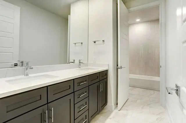 104 Lazy Oak Place Spicewood, TX 78669 - Photo 33 of 40 a bathroom with a sink and a mirror