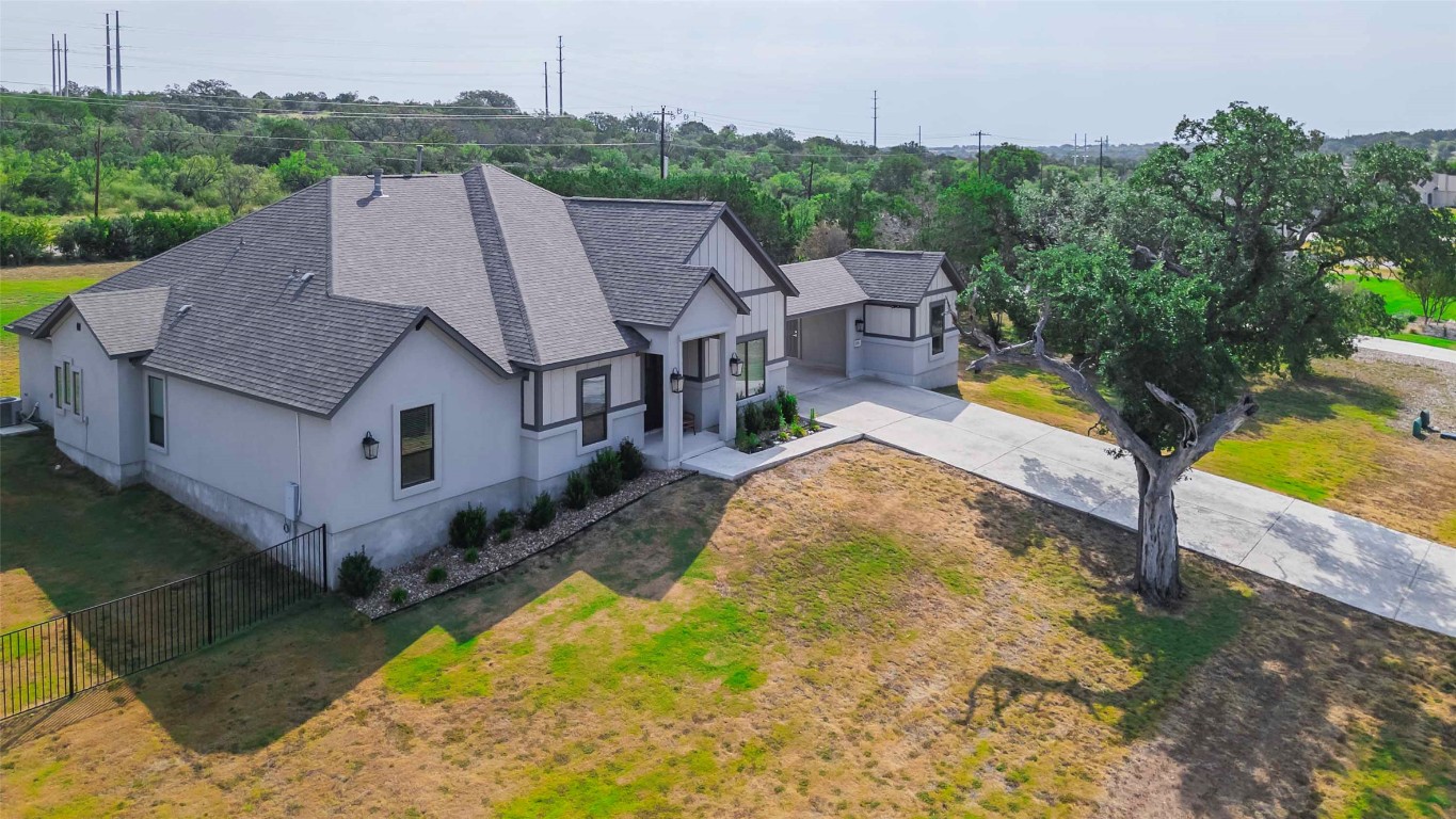 104 Lazy Oak Place Spicewood, TX 78669 - Photo 6 of 40 an aerial view of a house with swimming pool and garden