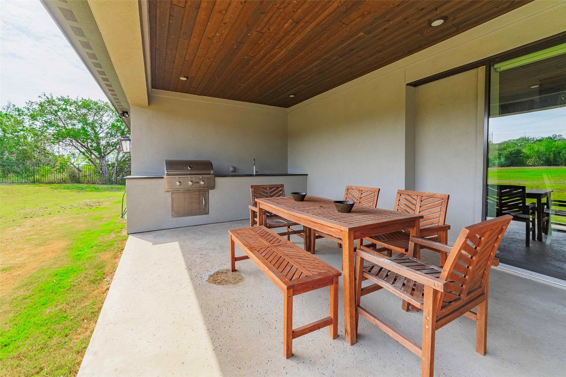 104 Lazy Oak Place Spicewood, TX 78669 - Photo 7 of 40 a dinning table and chairs in the terrace