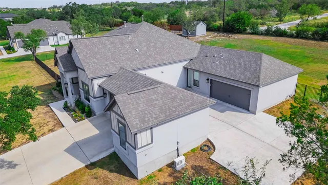 an aerial view of a house with backyard space and balcony