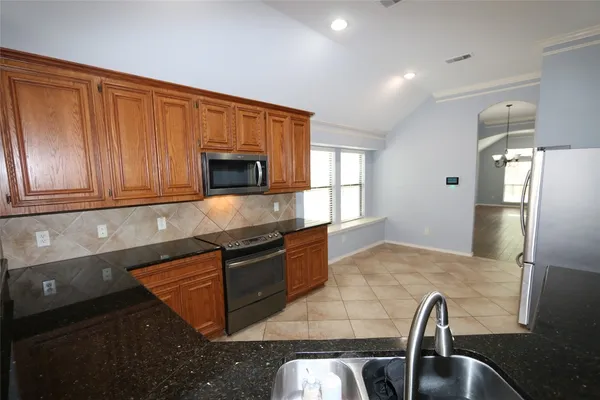 a stove top oven sitting inside of a kitchen