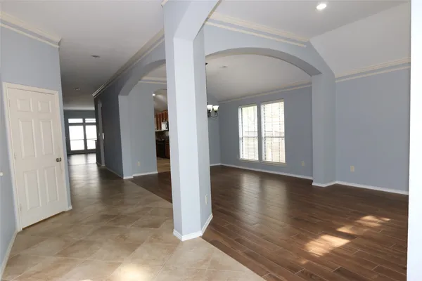 a view of an empty room with wooden floor