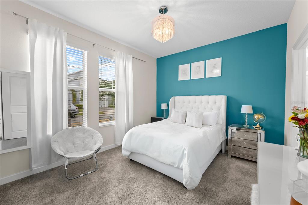 2926 Wordsmith Road Kissimmee, FL 34746 - Photo 5 of 42 a bedroom with a bed and a chair