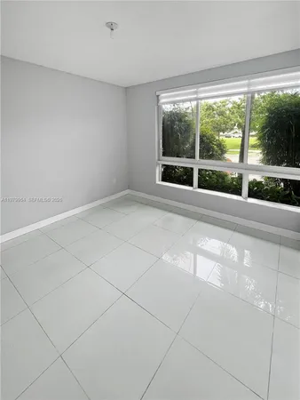 a view of an empty room with a large window