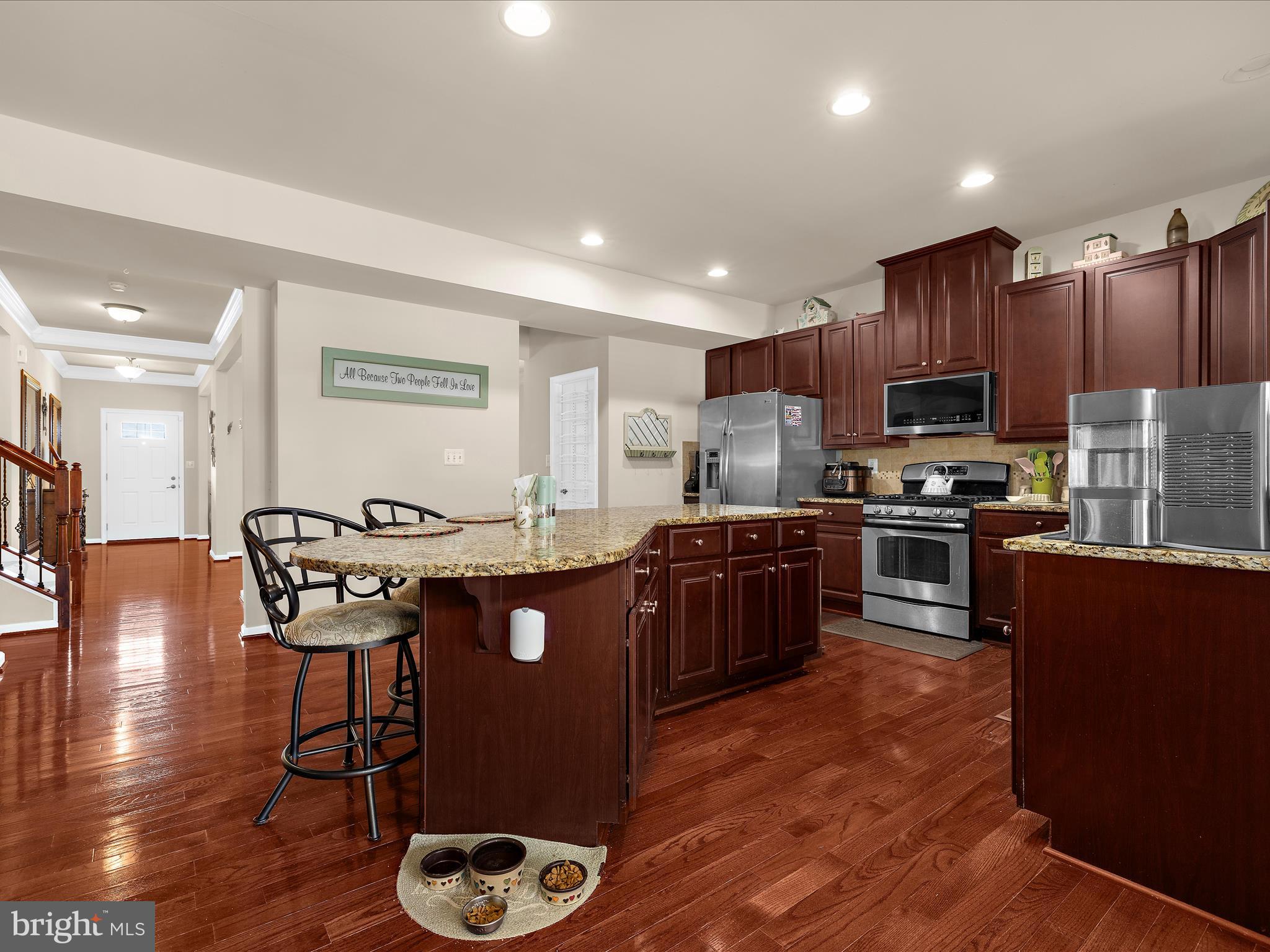 3314 Rosary Court Abingdon, MD 21009 - Photo 17 of 87 a kitchen with stainless steel appliances granite countertop a stove a refrigerator a sink a microwave dining table and chairs with wooden floor