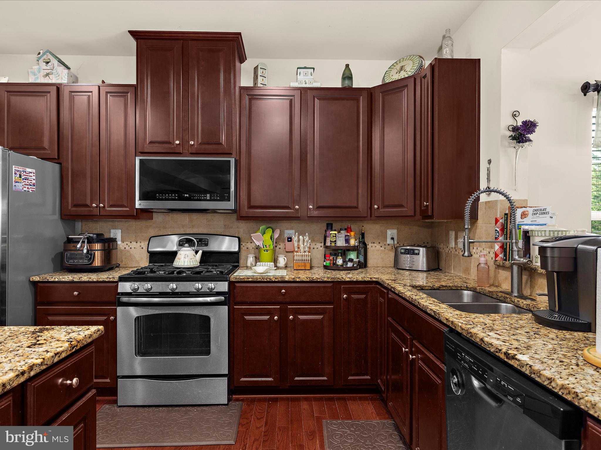 3314 Rosary Court Abingdon, MD 21009 - Photo 18 of 87 a kitchen with granite countertop wooden cabinets and stainless steel appliances